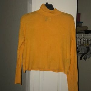 Bright yellow turtle neck !